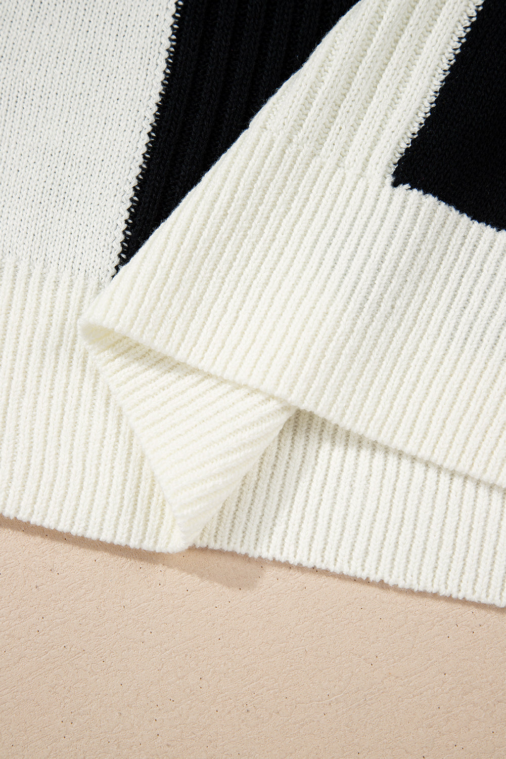 Close-up of a white and black patterned fabric on a beige surface