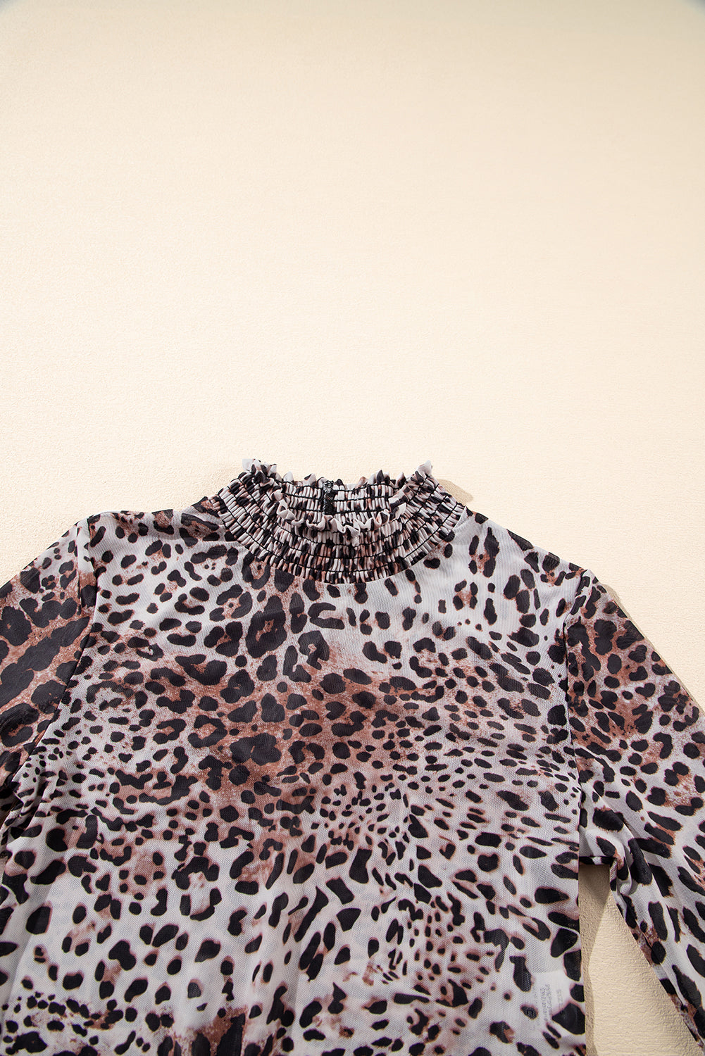 Leopard print top on a beige background