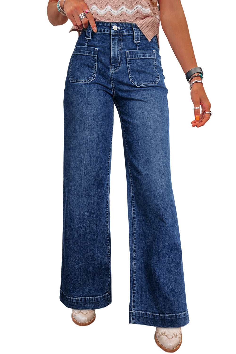 Person wearing blue wide-leg jeans on a white background