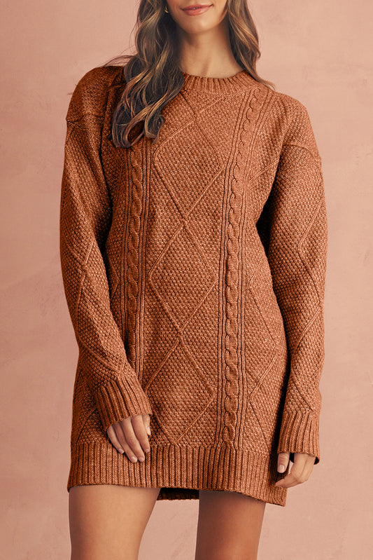 Brown cable knit sweater dress worn by a person on a pink background