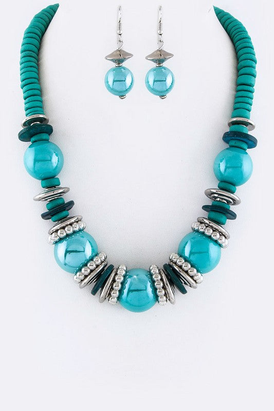 Turquoise beaded necklace and earrings on a white background