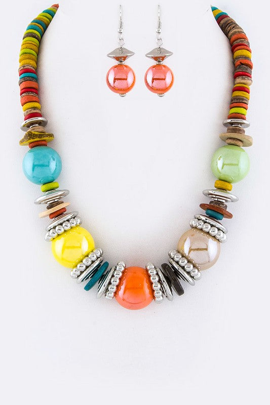 Colorful beaded necklace and earrings on a white background