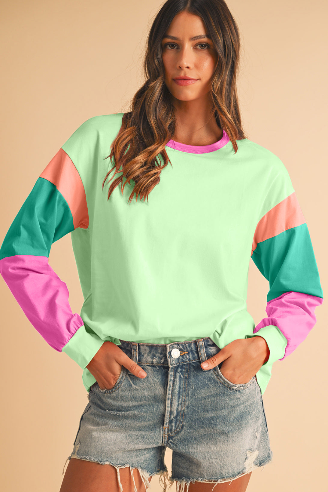 Woman wearing a colorful sweater with a beige background