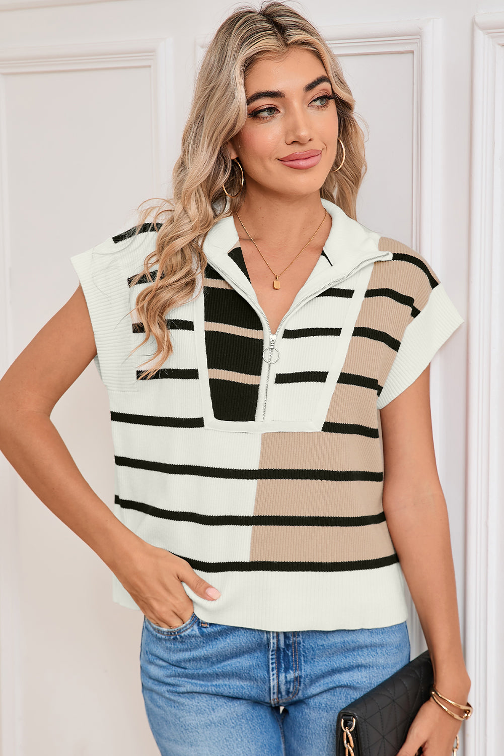 Woman wearing a sleeveless striped shirt with a neutral color palette.