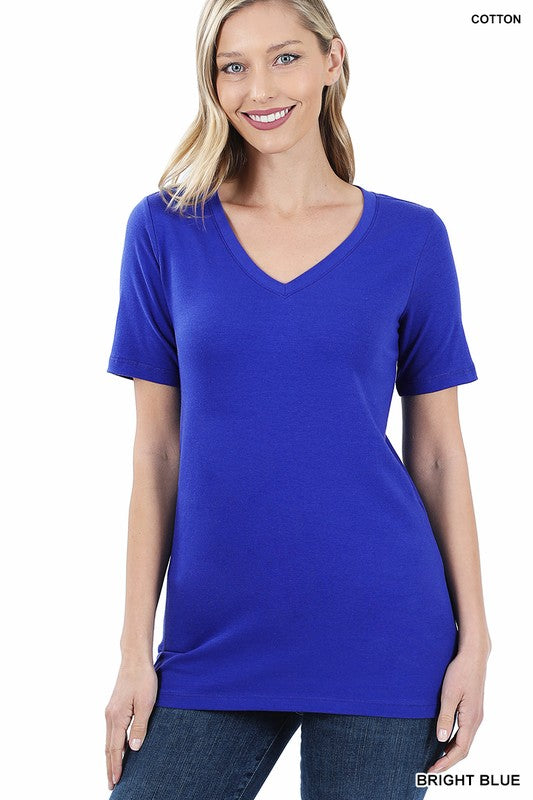 Woman wearing a bright blue t-shirt on a white background