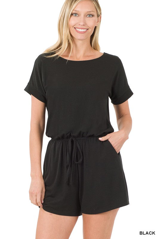 Woman wearing a black romper on a white background