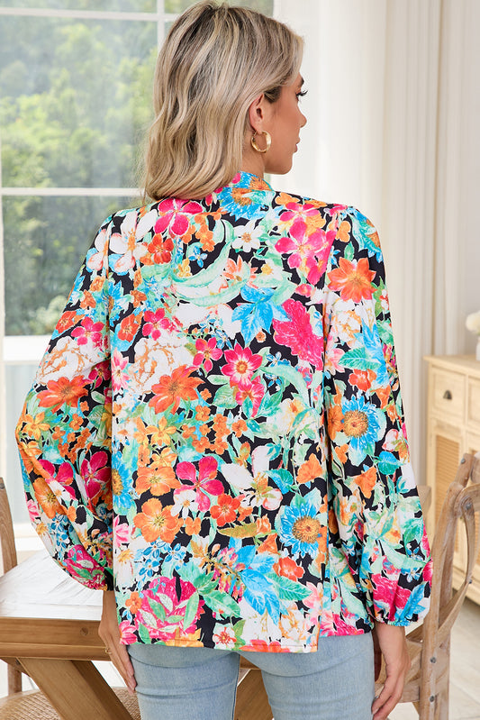 Person wearing a colorful floral blouse indoors