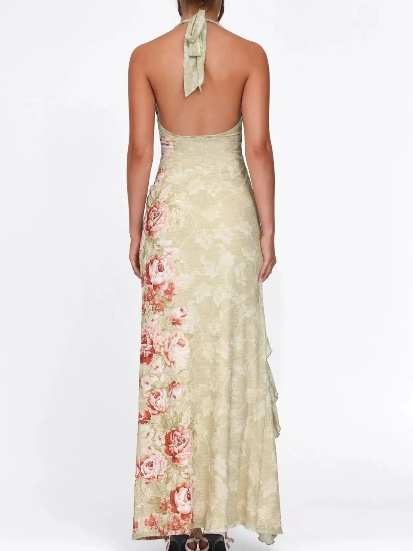 Woman wearing a floral halter neck dress on a white background