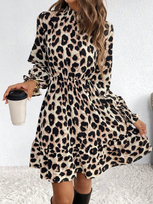 Person wearing a leopard print dress holding a coffee cup against a white background