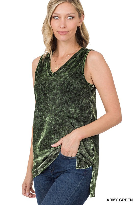 Woman wearing an army green sleeveless top with a white background