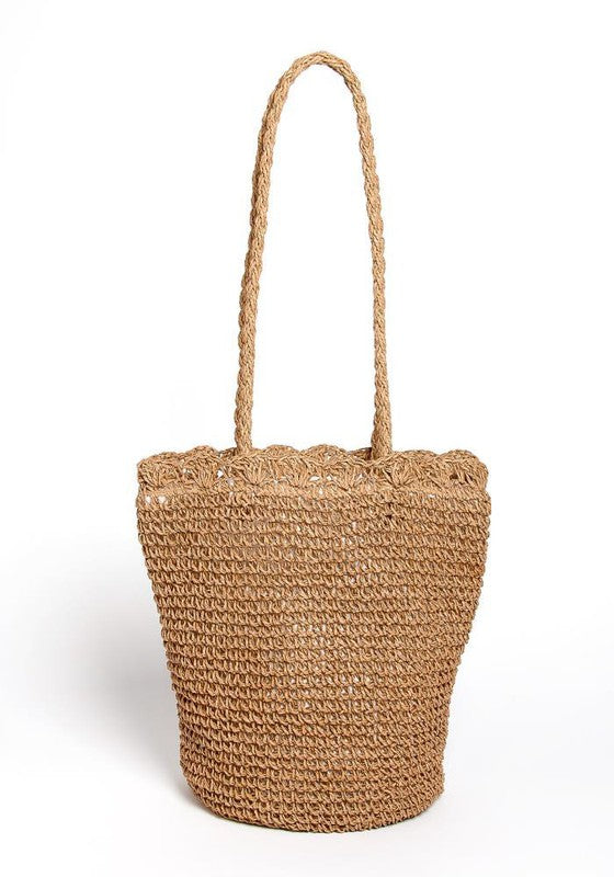 Woven straw bag with a handle on a white background
