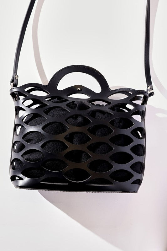 Black perforated handbag with a strap on a white background