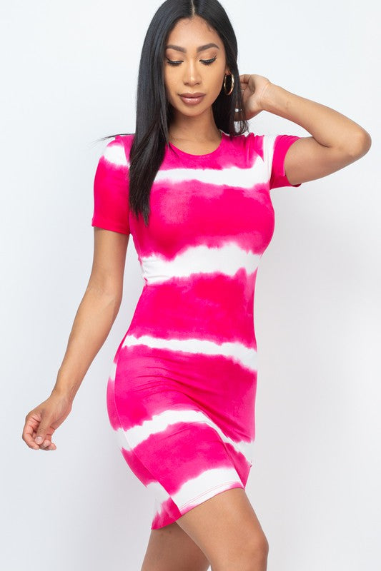 Woman wearing a pink and white tie-dye dress on a plain background