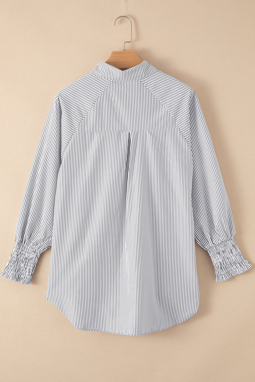 Blue and white striped shirt on a beige background