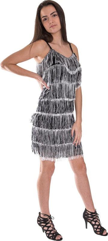 Woman wearing a black and white fringe dress on a white background