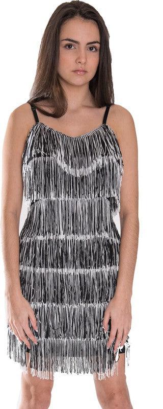 Woman wearing a black and white fringe dress on a white background