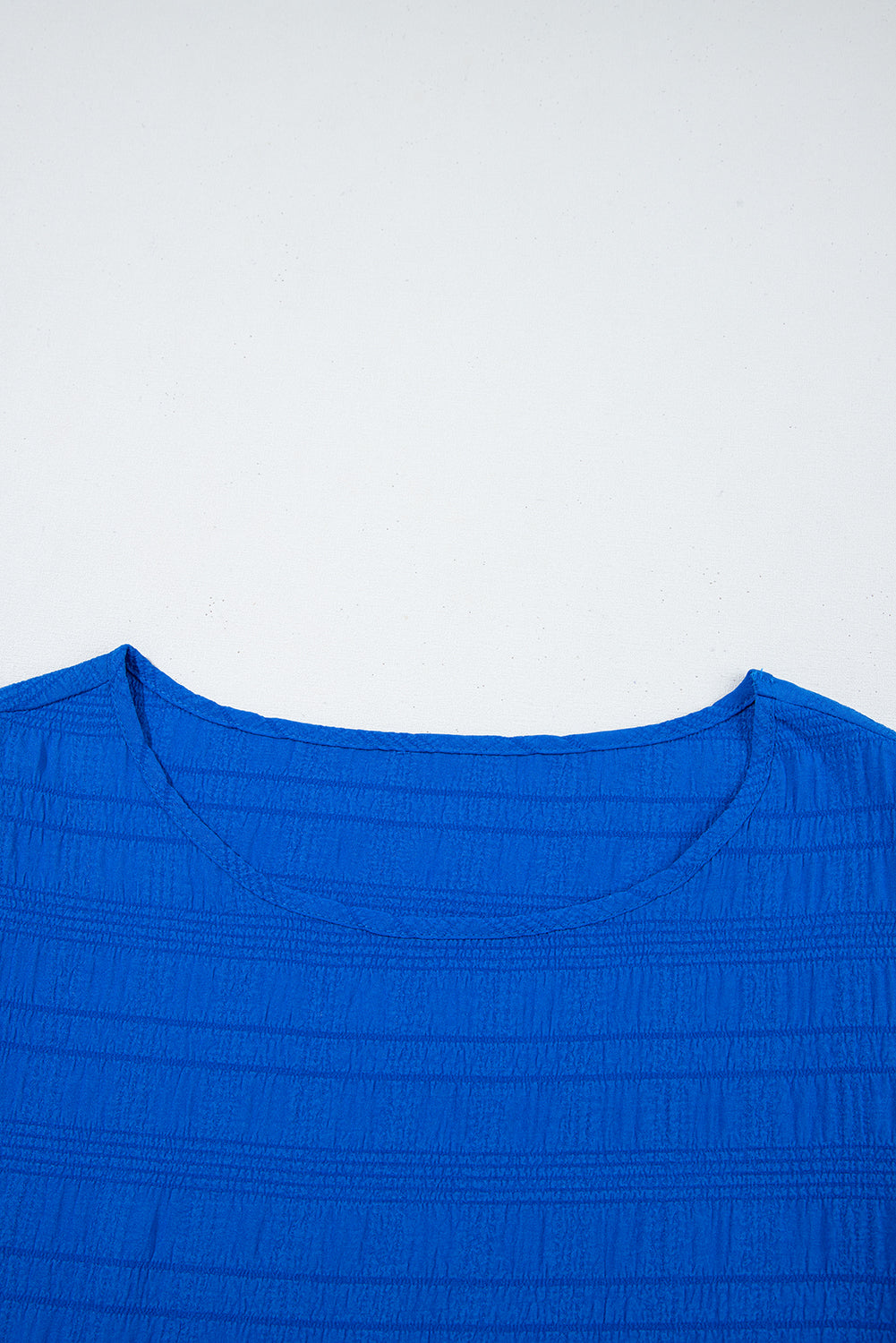 Close-up of a blue garment with a white background