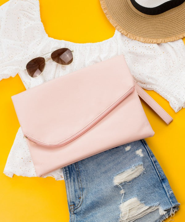 Pink clutch bag, sunglasses, and denim jeans on a yellow background