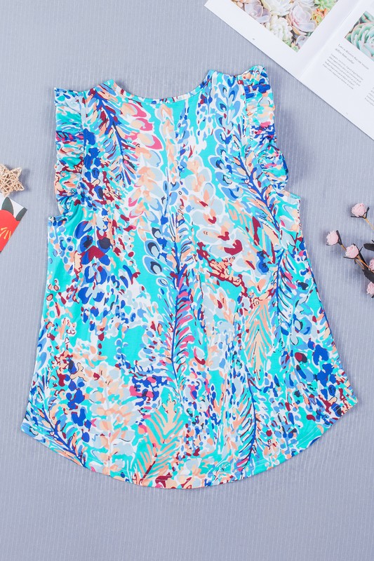 Colorful floral-patterned top on a gray surface with a magazine in the background