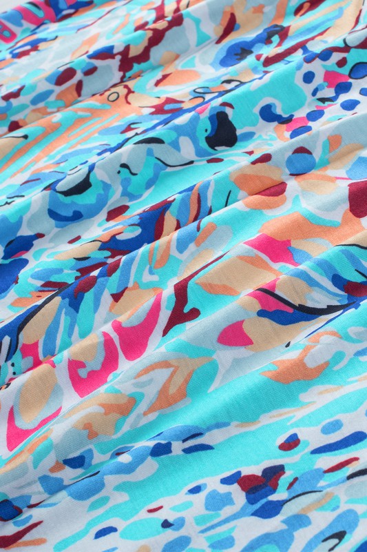 Colorful abstract patterned fabric with a mix of blue, pink, orange, and red.