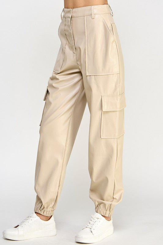 Beige cargo pants worn by a person on a white background
