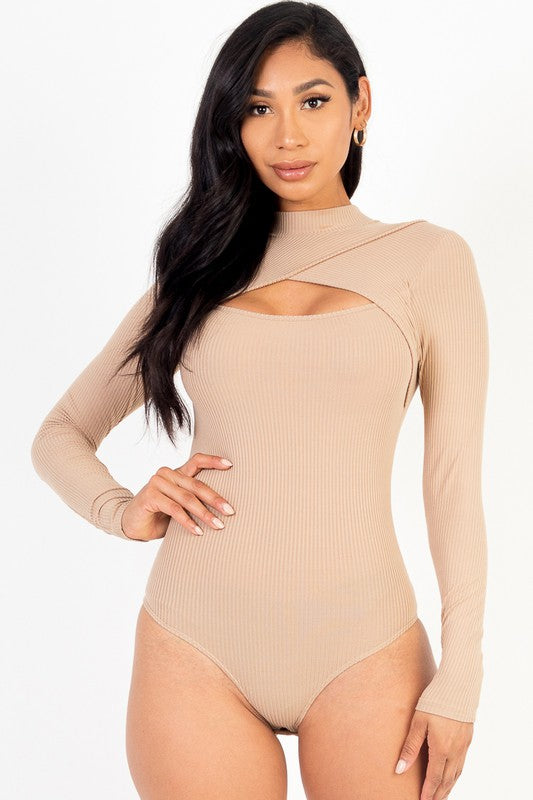 Woman wearing a beige ribbed bodysuit with cut-out design on a white background