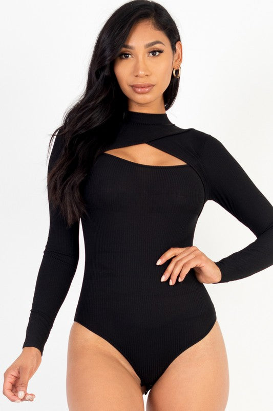 Woman wearing a black long-sleeve bodysuit with cut-out design on a white background