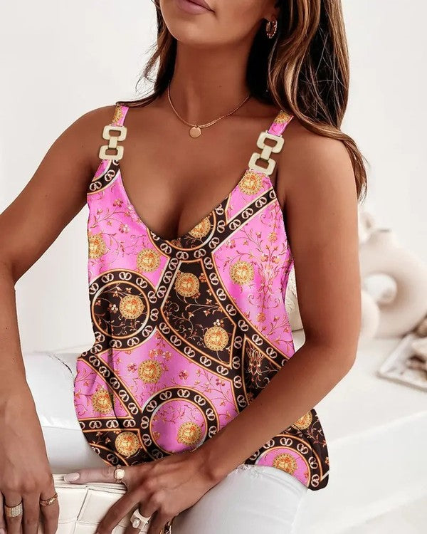 Woman wearing a pink and gold patterned top with a blurred background