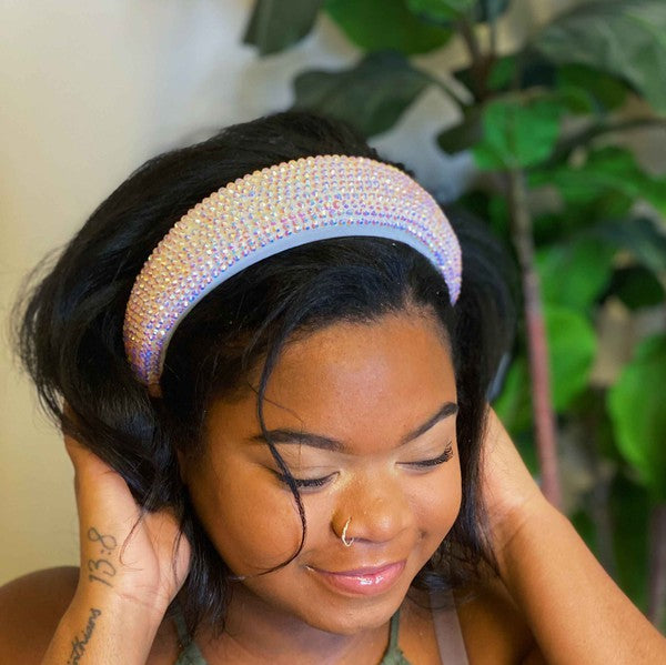 Woman wearing a decorative headband with a plant in the background