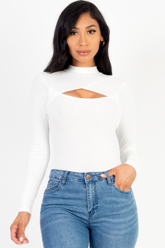Woman wearing a white cut-out top and blue jeans on a white background