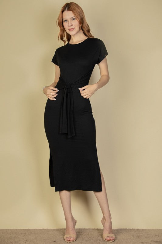 Woman wearing a black dress against a beige background