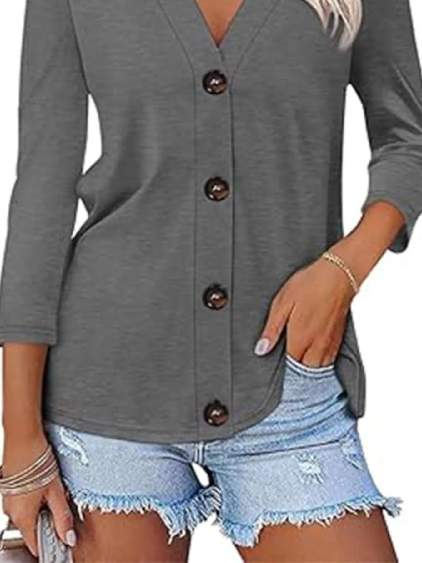Gray button-up cardigan worn by a person with denim shorts.