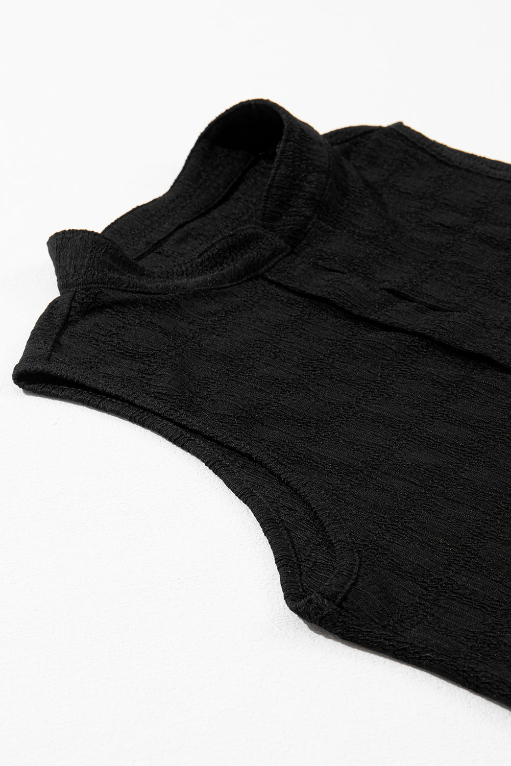 Black sleeveless top on a white background