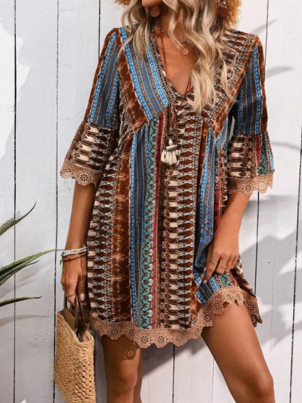 Woman wearing a patterned dress with a wooden background