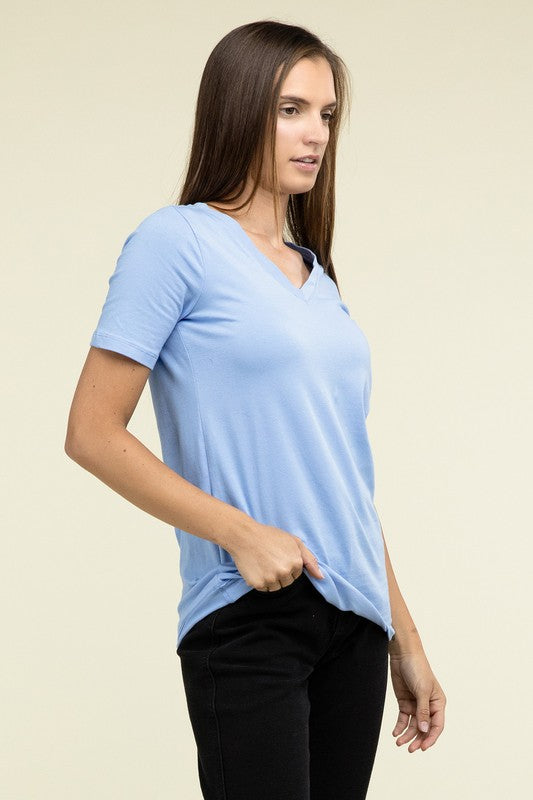 Woman wearing a light blue t-shirt against a beige background