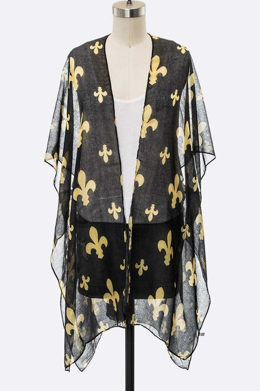 Black sheer cardigan with gold fleur-de-lis pattern on a mannequin against a white background
