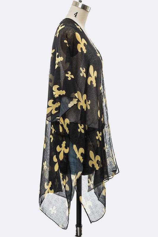 Black sheer top with gold floral patterns on a mannequin against a white background