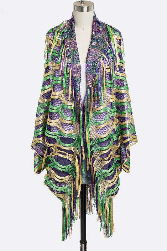 Colorful patterned shawl with fringe on a mannequin against a white background