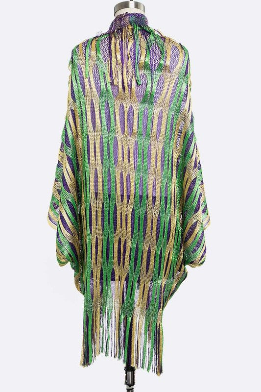Colorful patterned shawl with fringe on a mannequin against a white background