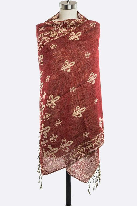 Red scarf with gold patterns on a mannequin against a white background