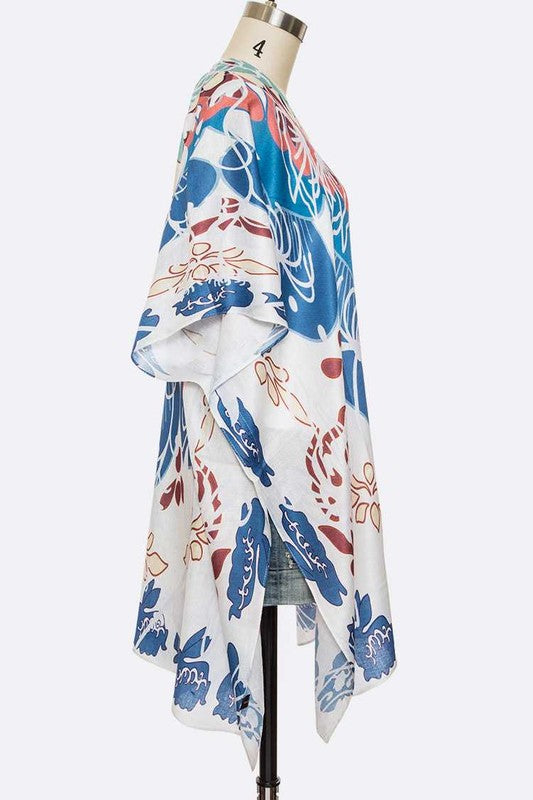 Colorful floral kimono on a mannequin against a white background