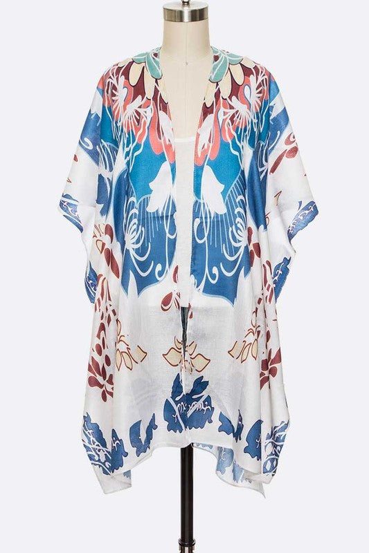 Colorful floral kimono on a mannequin against a white background