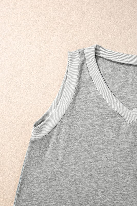 Gray tank top with ribbed trim on a beige background