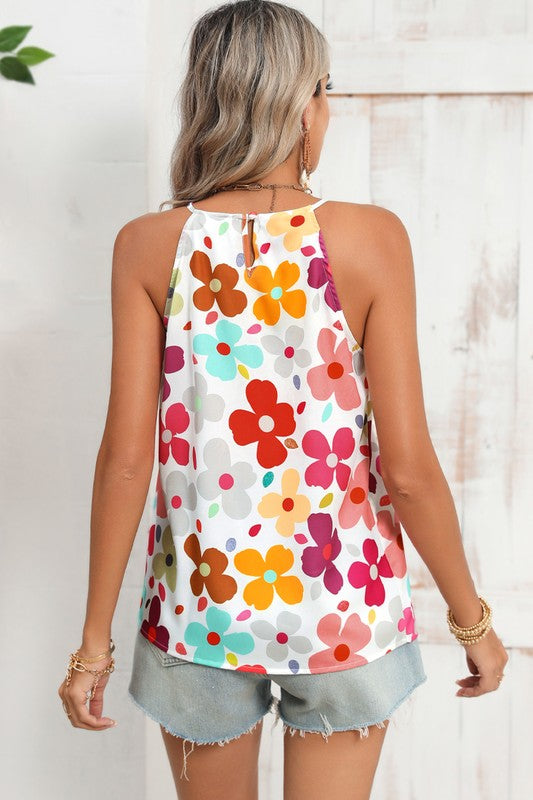 Woman wearing a colorful floral tank top with a white background