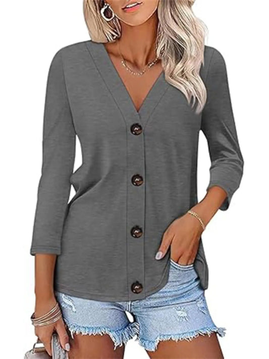 Woman wearing a gray button-up cardigan over denim shorts on a white background