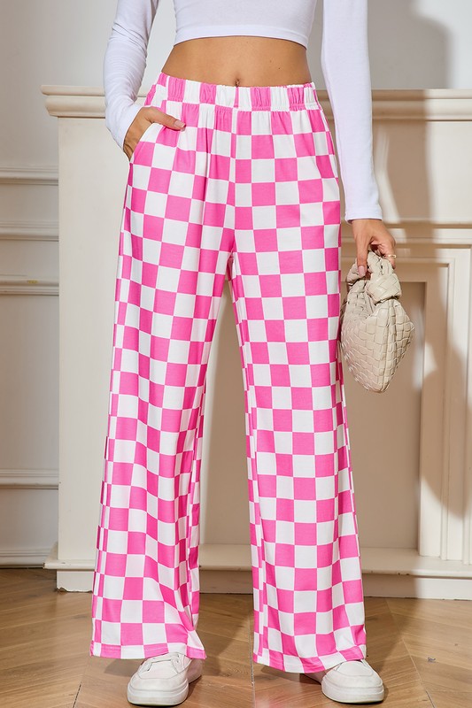 Person wearing pink and white checkered pants indoors.