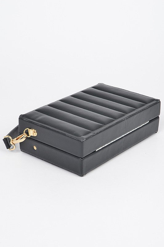 Black jewelry box with gold accents on a white background