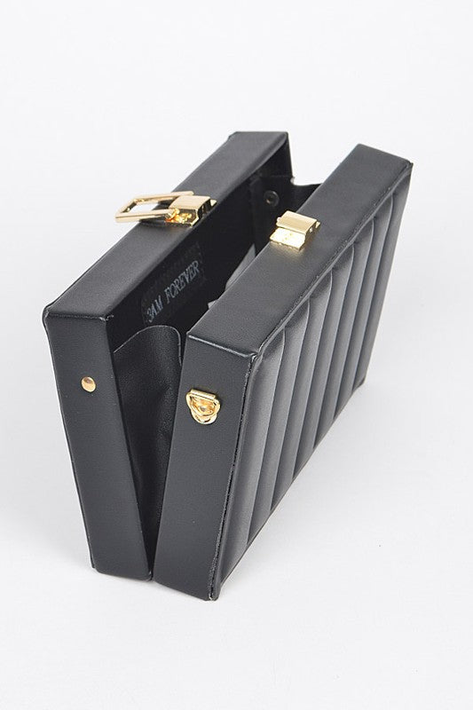Black clutch bag with gold accents on a white background