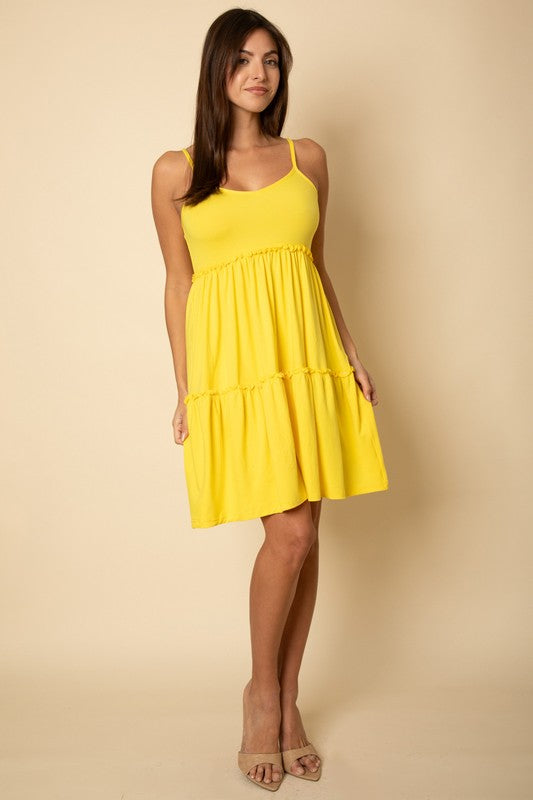 Woman wearing a yellow dress against a beige background