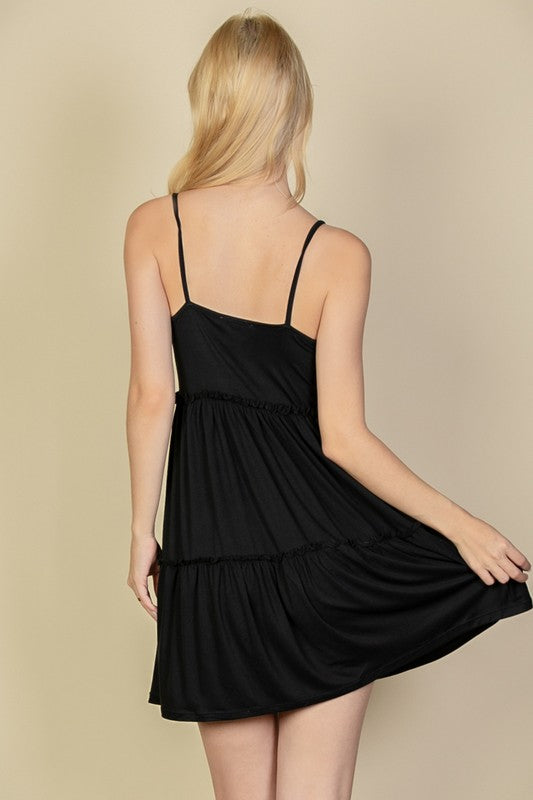 Woman wearing a black dress against a beige background